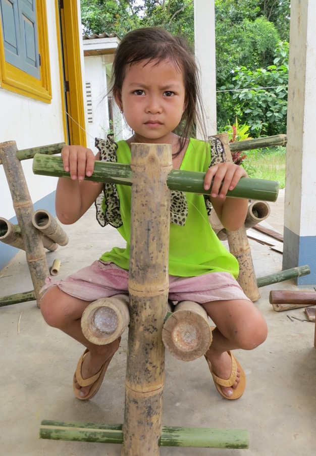 little lao girl on bamboo swing